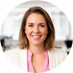 Sarah smiling in a bright office portrait with a neutral background